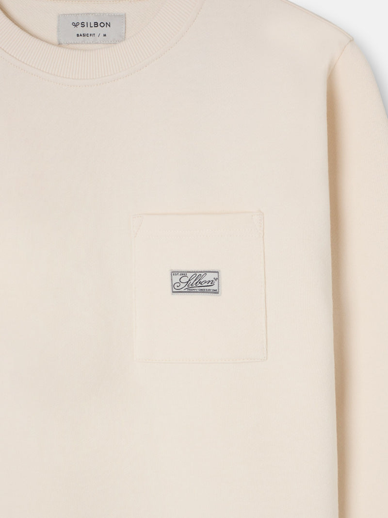 Cream sweatshirt with pocket and label