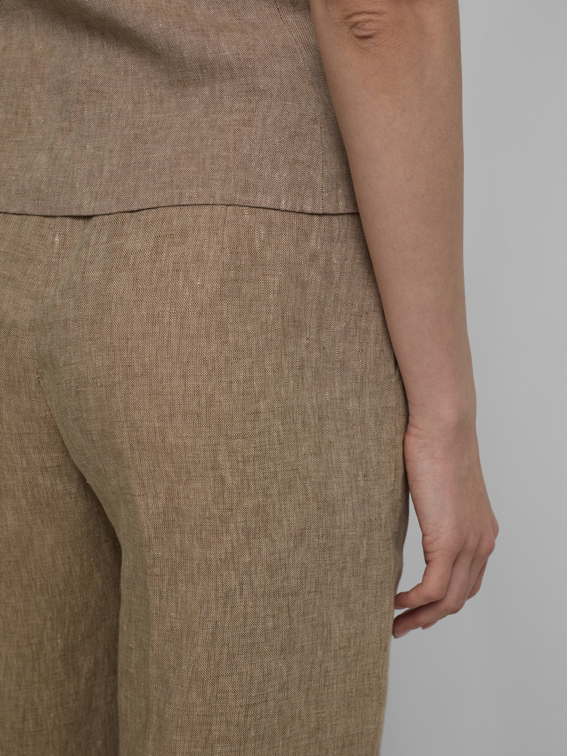 Straight beige trousers with slits