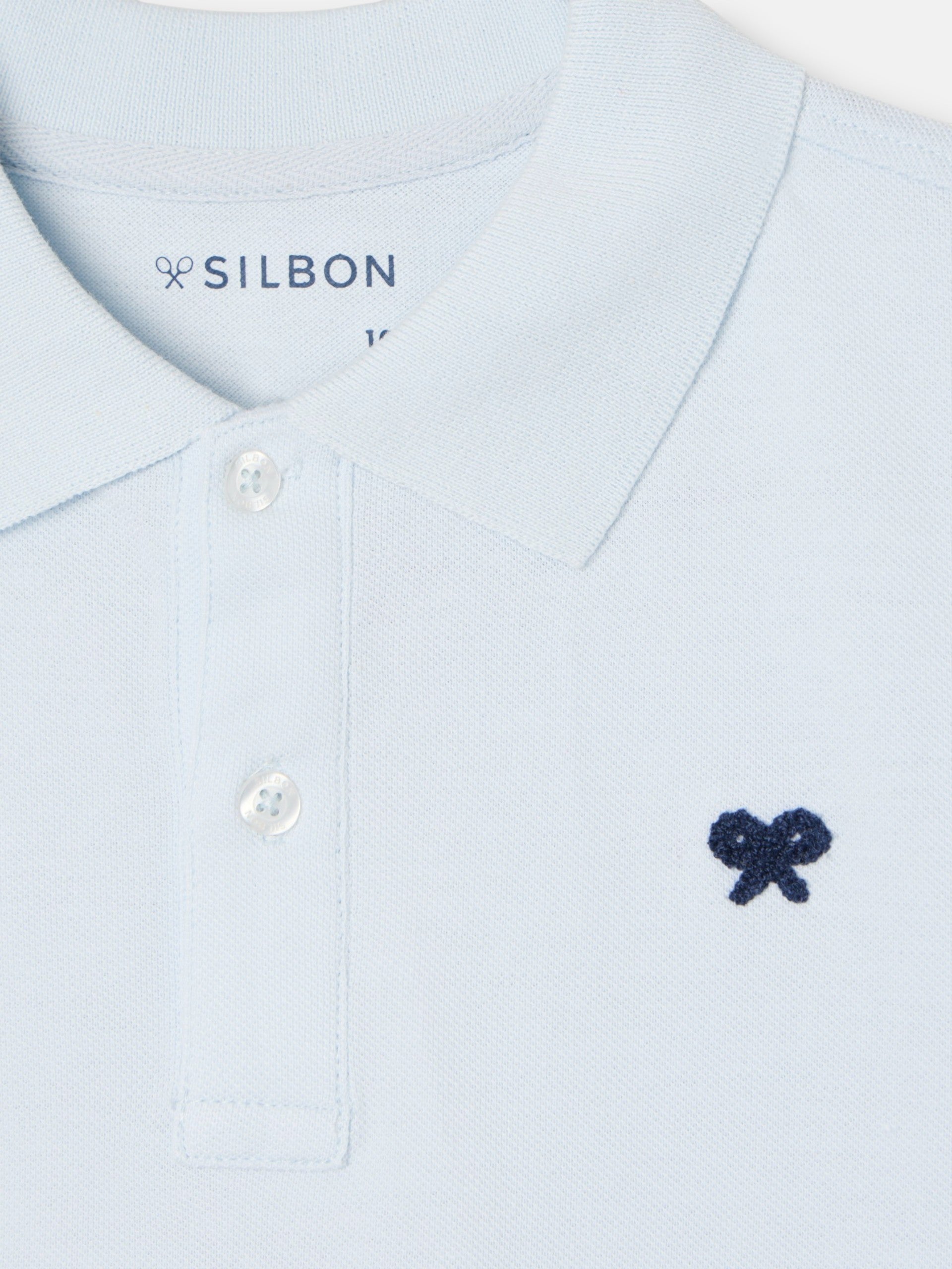 Polo enfant uni logo bouclé bleu clair