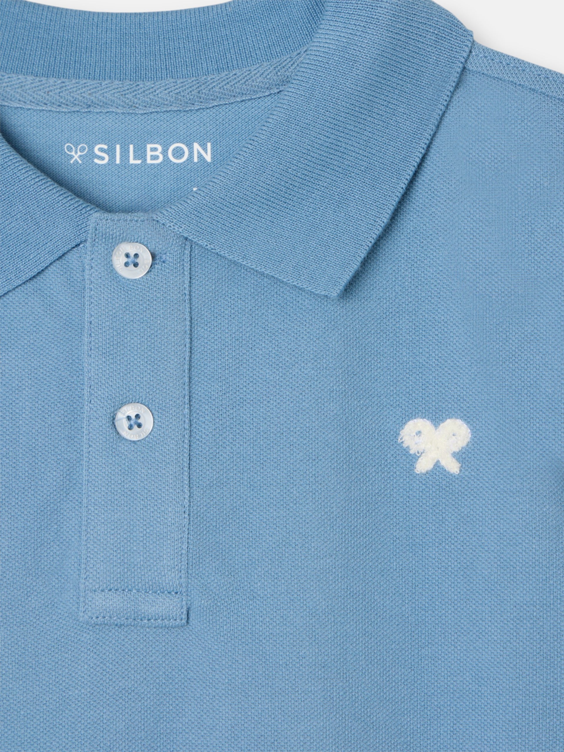 Polo enfant uni logo bouclé bleu moyen