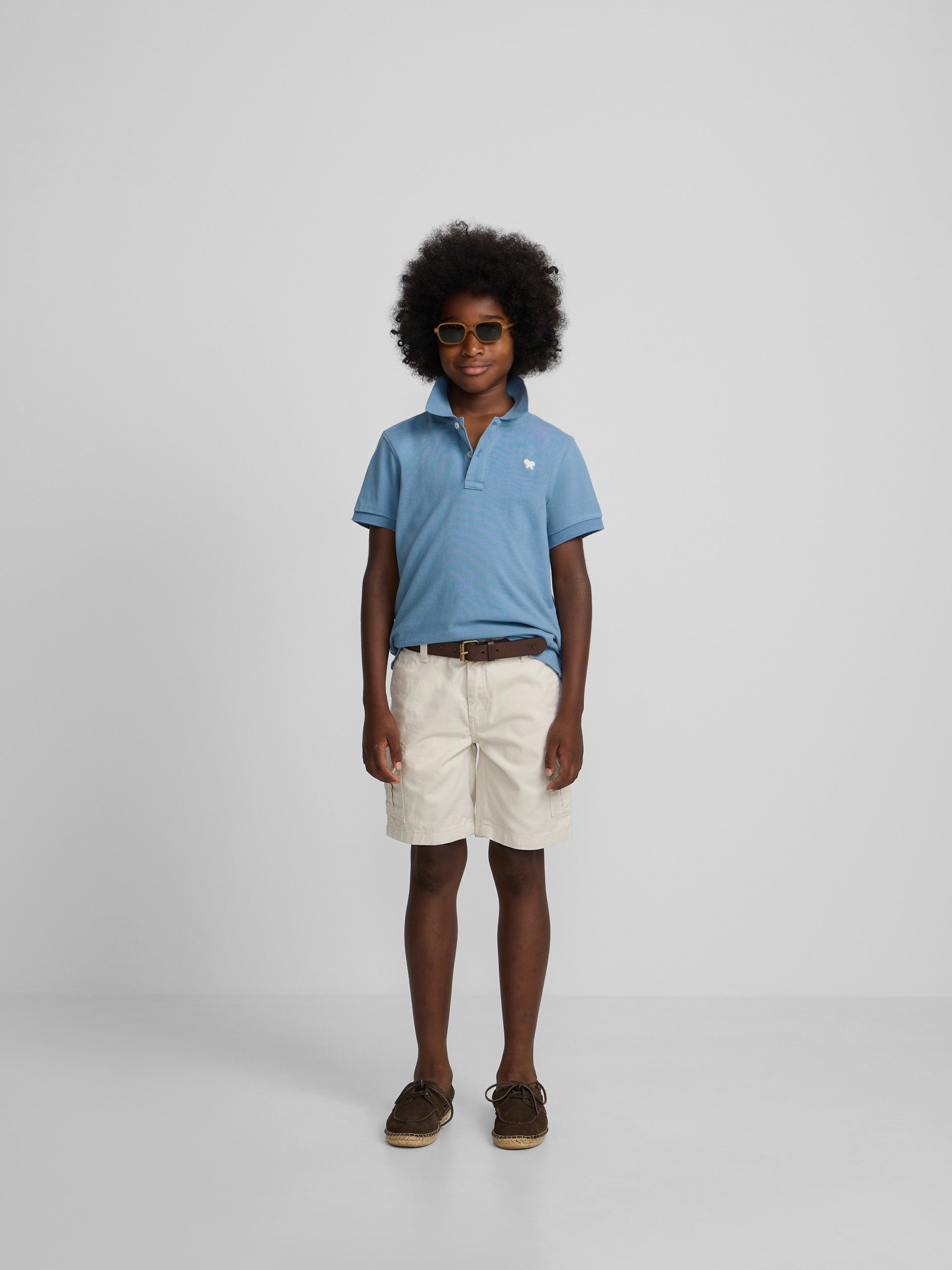 Polo enfant uni logo bouclé bleu moyen
