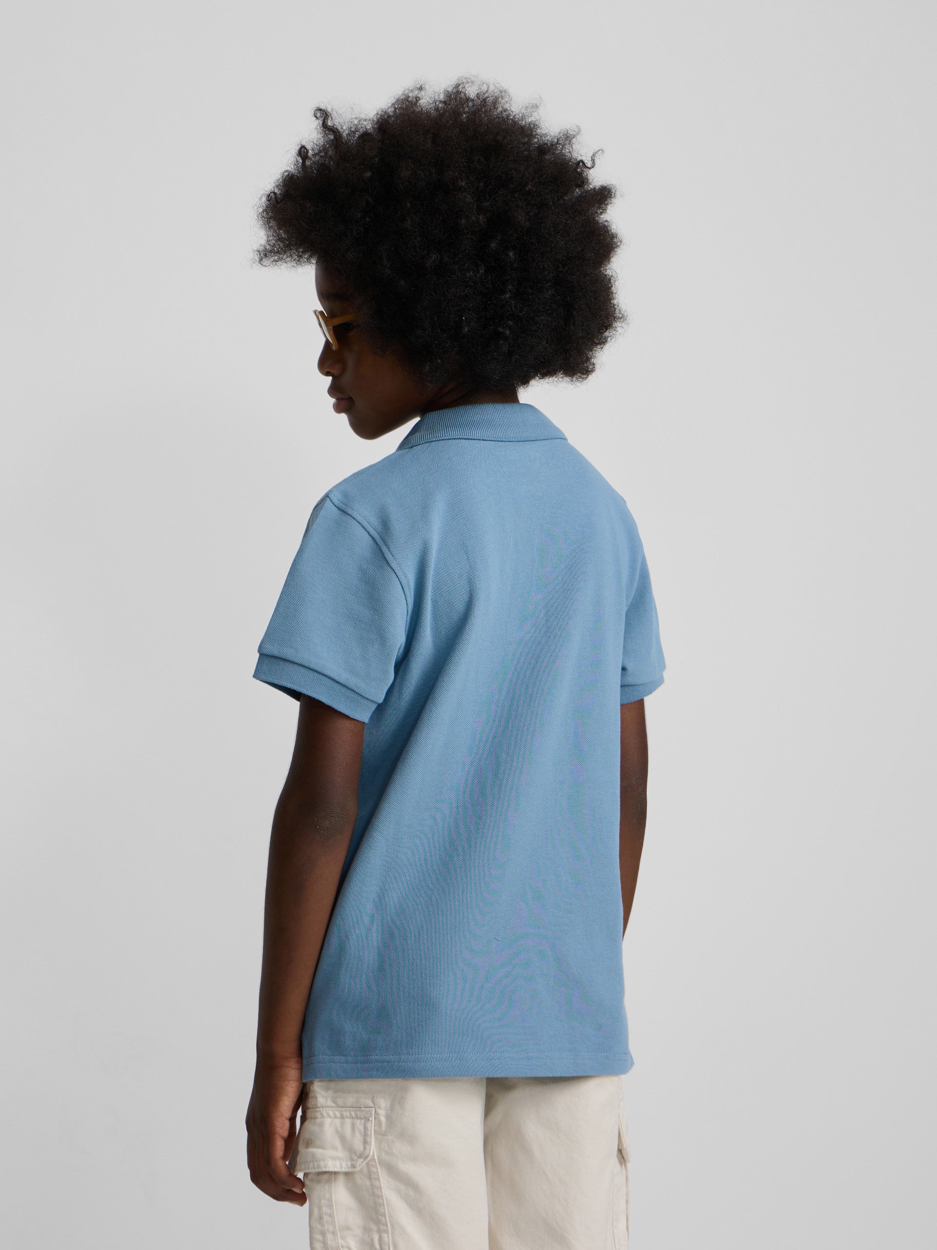 Polo enfant uni logo bouclé bleu moyen