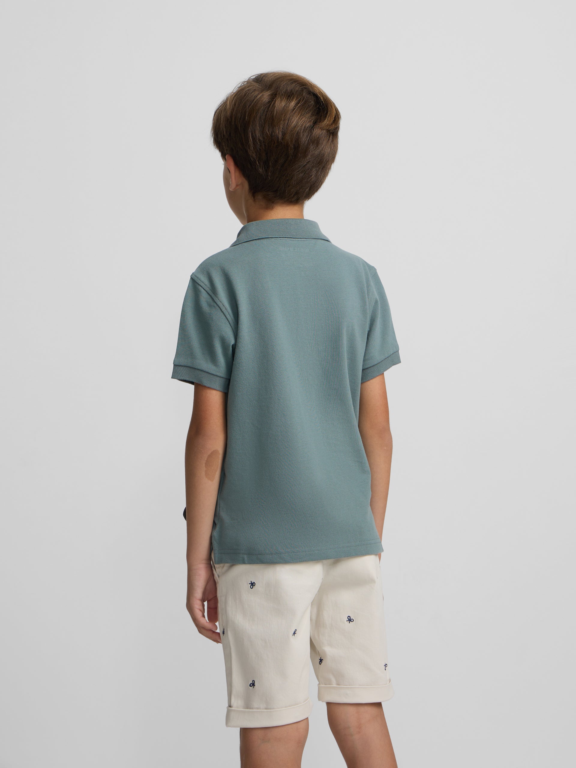 Polo criança liso com logótipo em felpa verde escuro