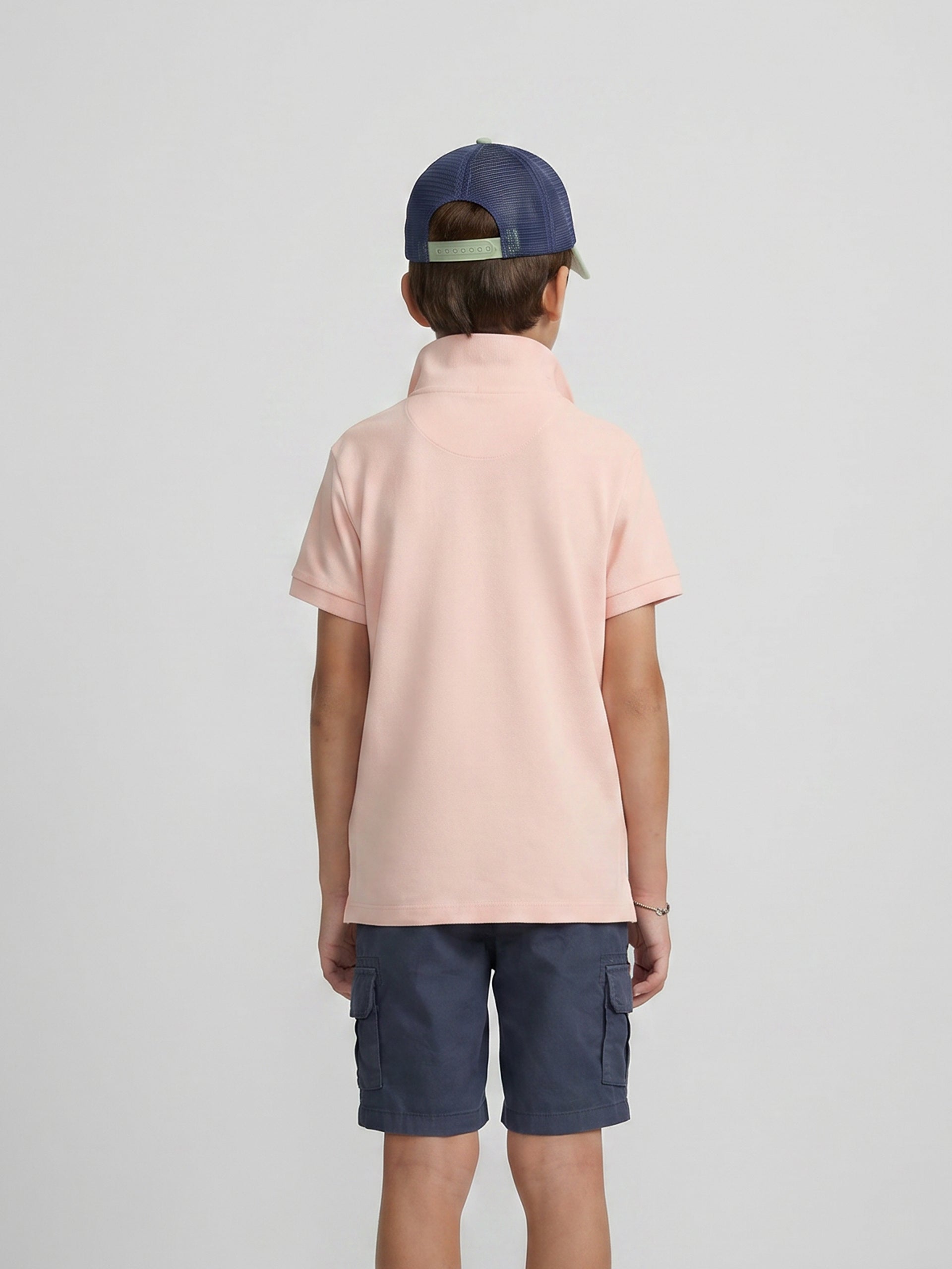 Polo enfant uni logo bouclé corail