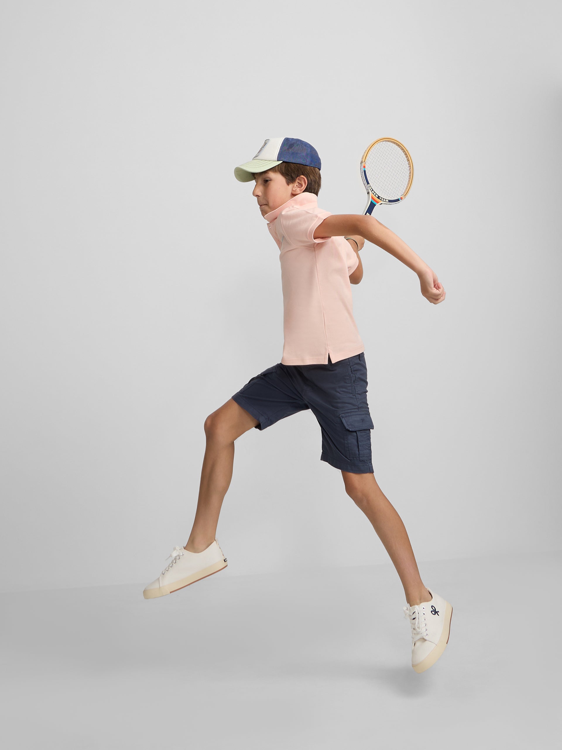 Polo enfant uni logo bouclé corail
