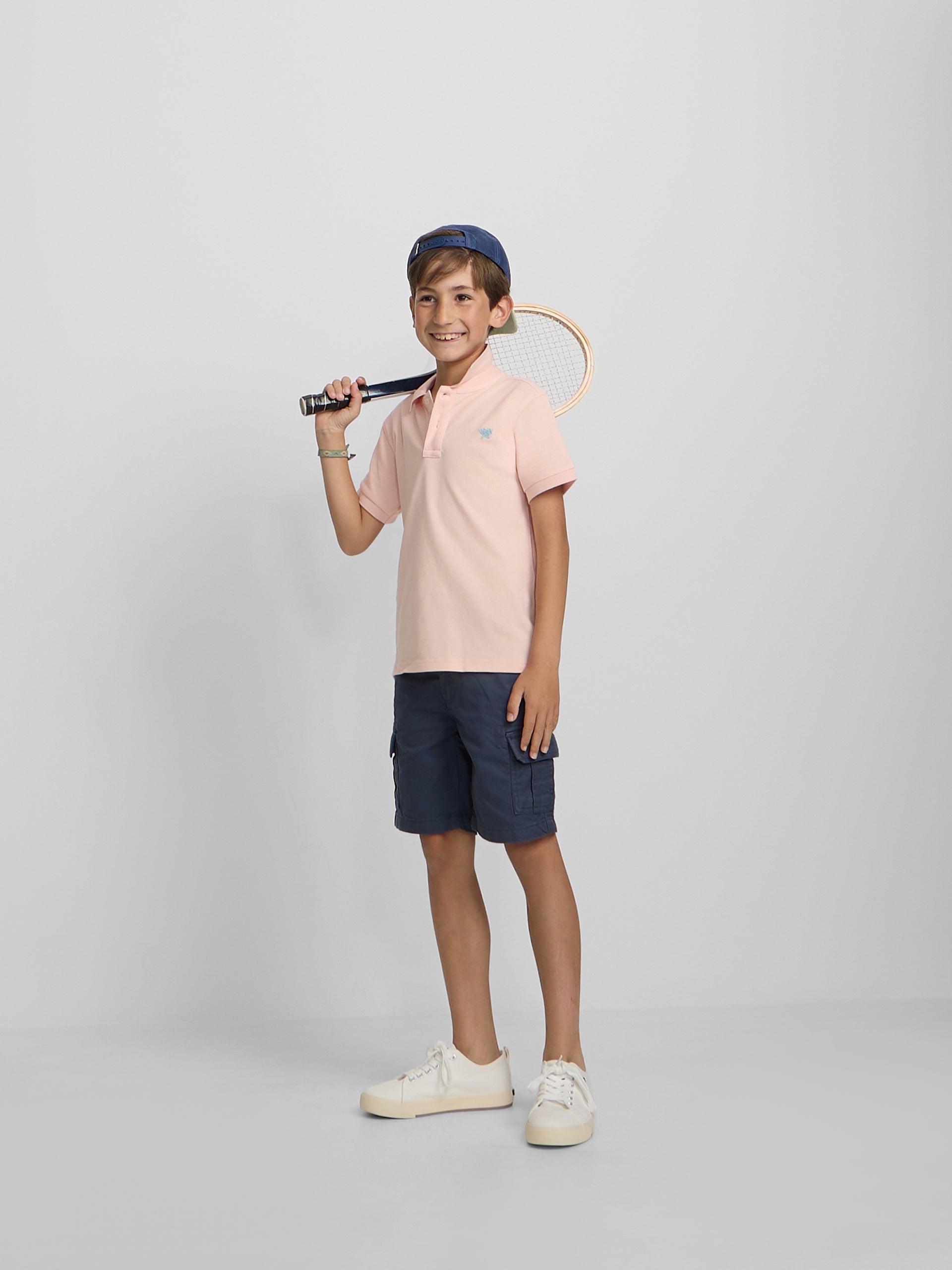 Polo enfant uni logo bouclé corail