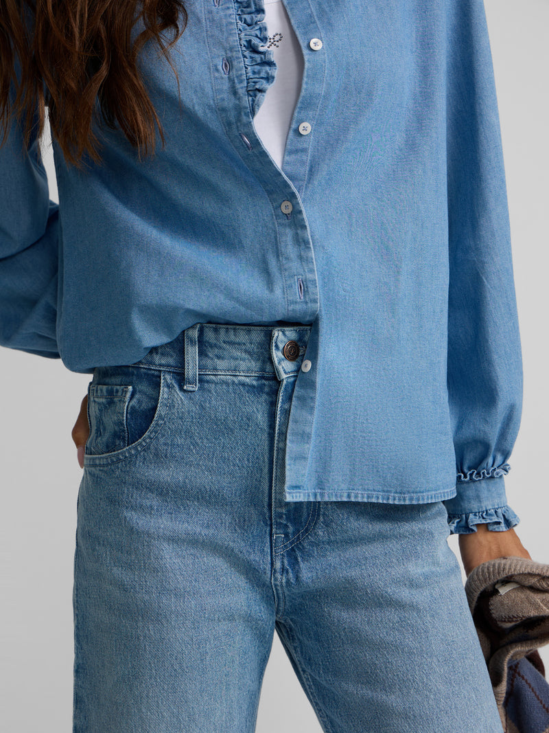 Denim shirt with ruffle collar and cuff detail