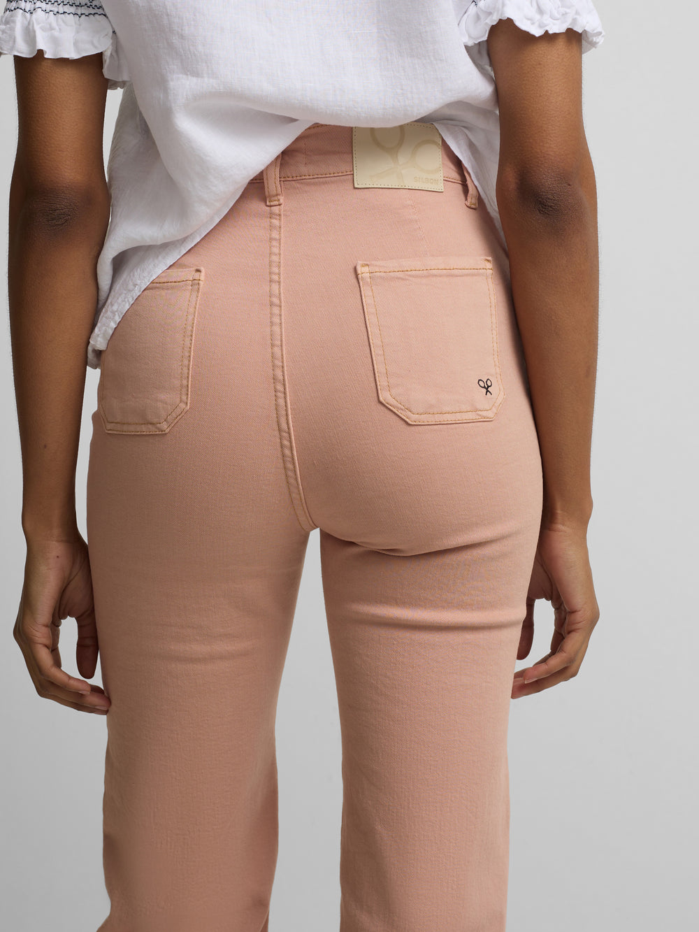 Pantalon en denim à boucles corail