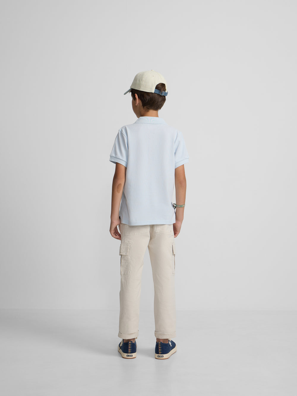 Polo enfant uni logo bouclé bleu clair