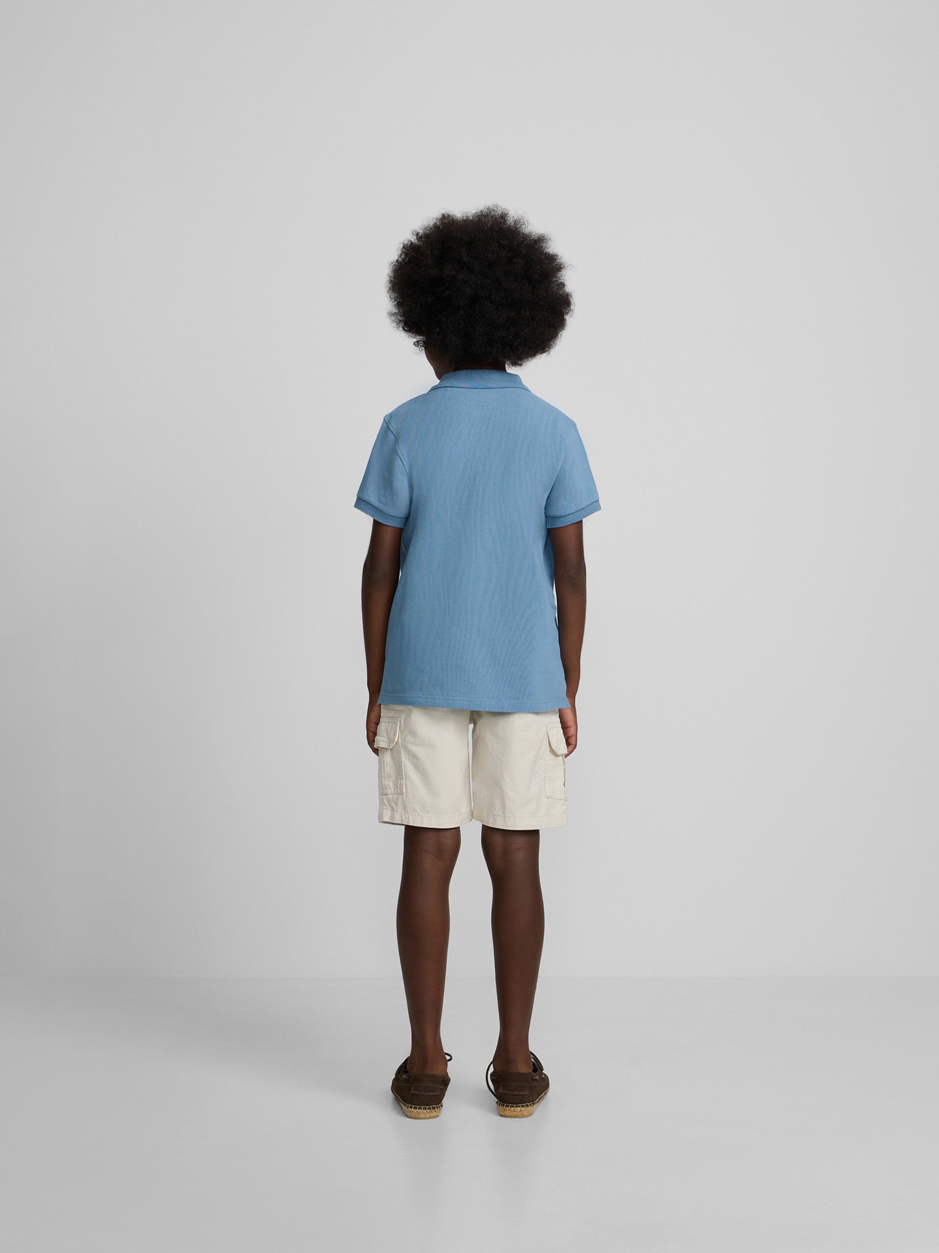Polo enfant uni logo bouclé bleu moyen