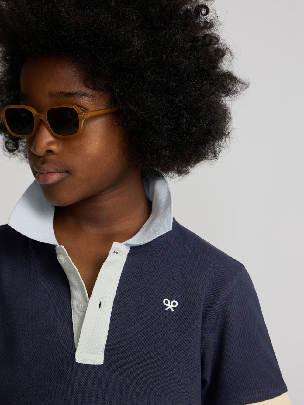 Navy blue kids polo with multicolor trim