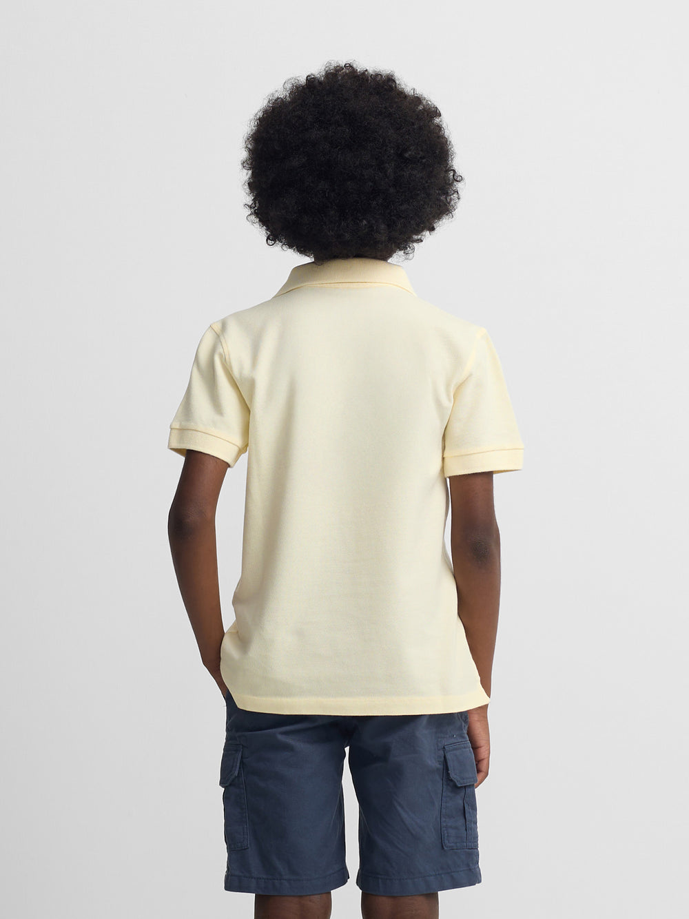 Polo enfant uni logo bouclé jaune