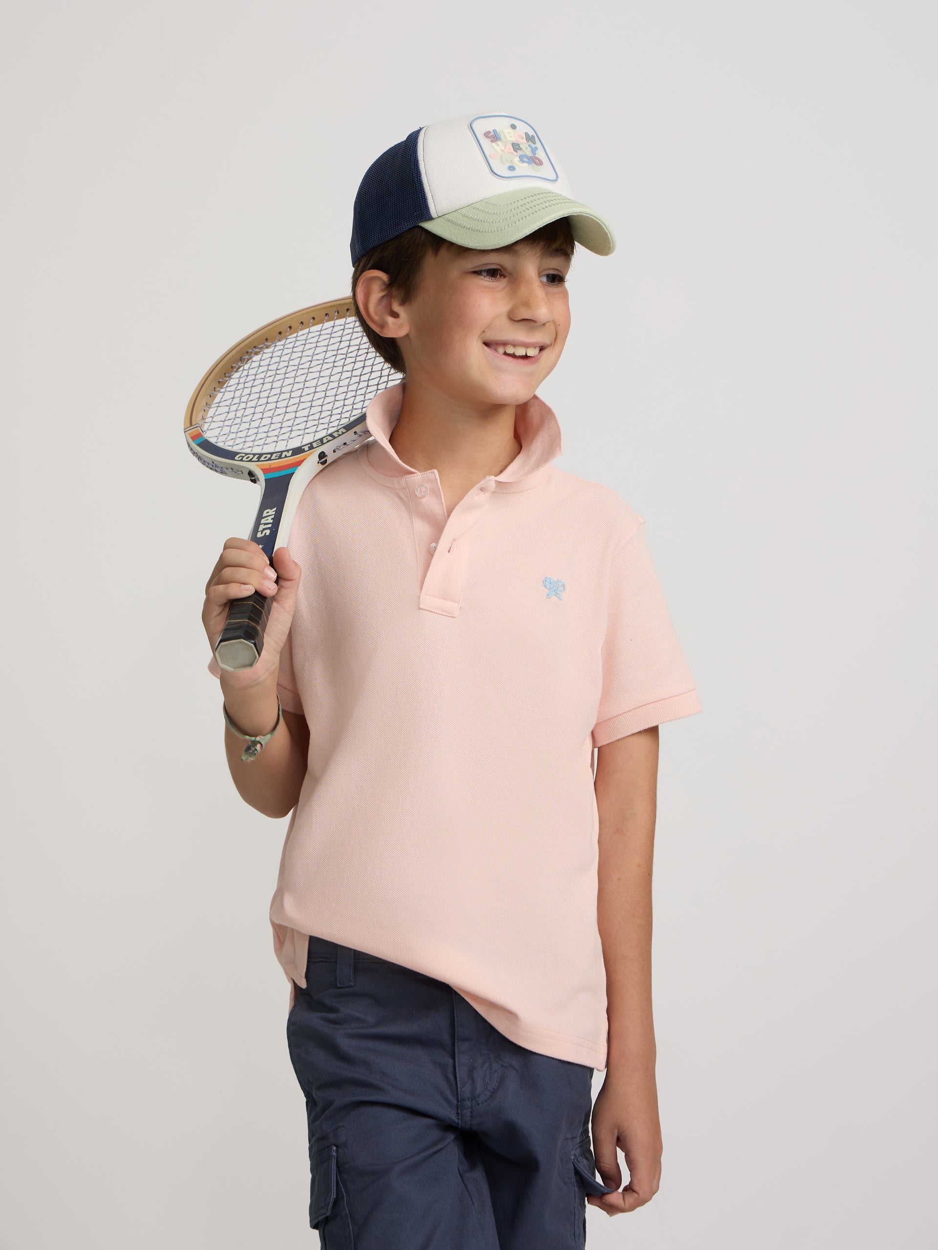 Polo enfant uni logo bouclé corail