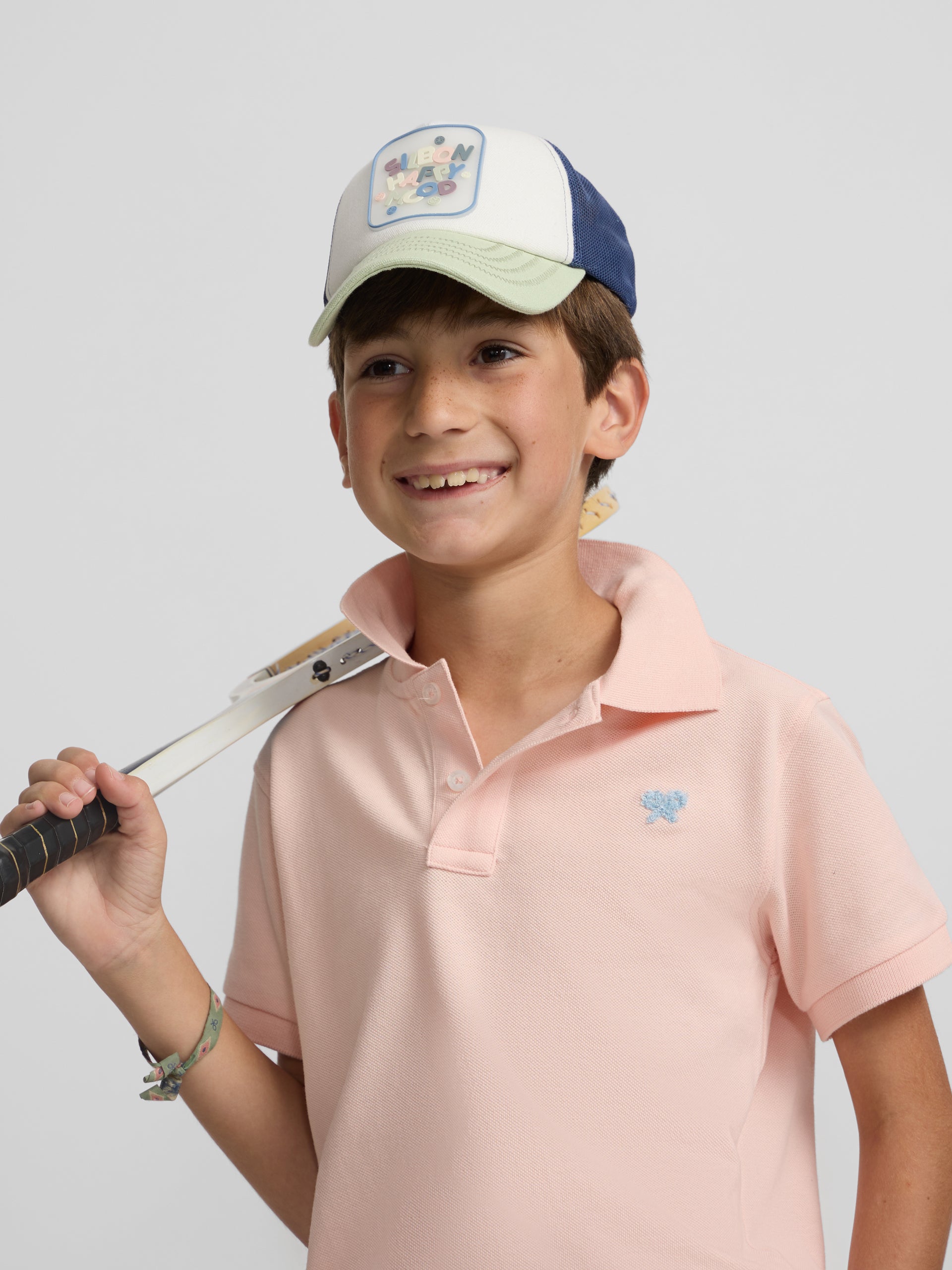 Polo enfant uni logo bouclé corail